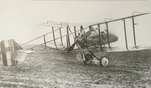 an old airplane sitting on top of a grass covered field