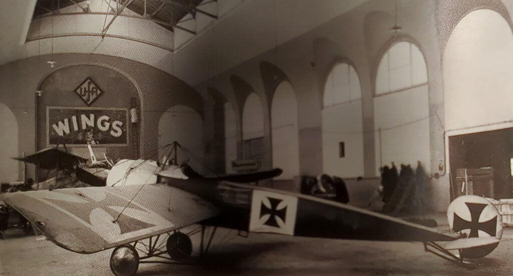 a black and white photo of an airplane inside of a building