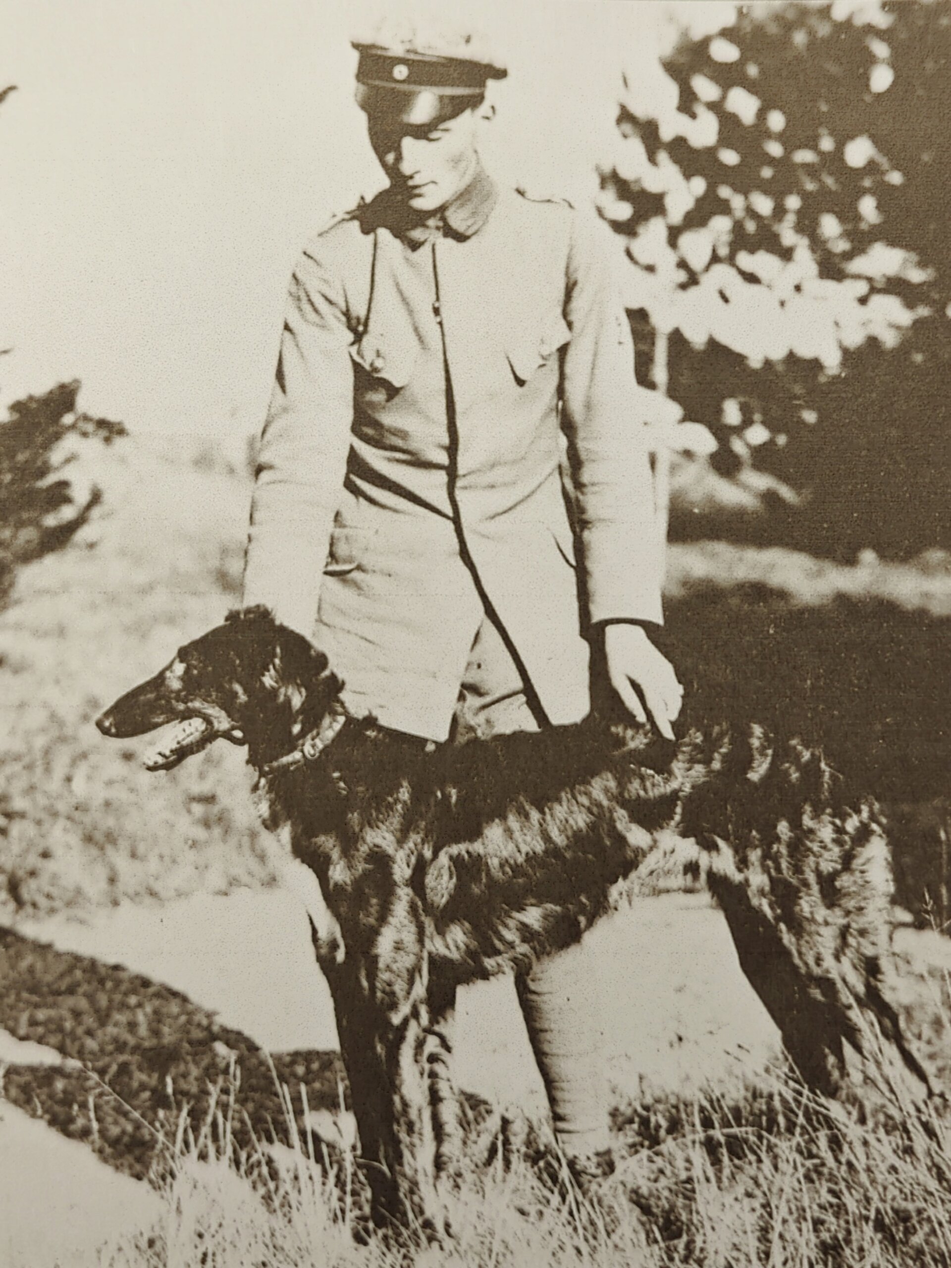 an old photo of a man with a dog