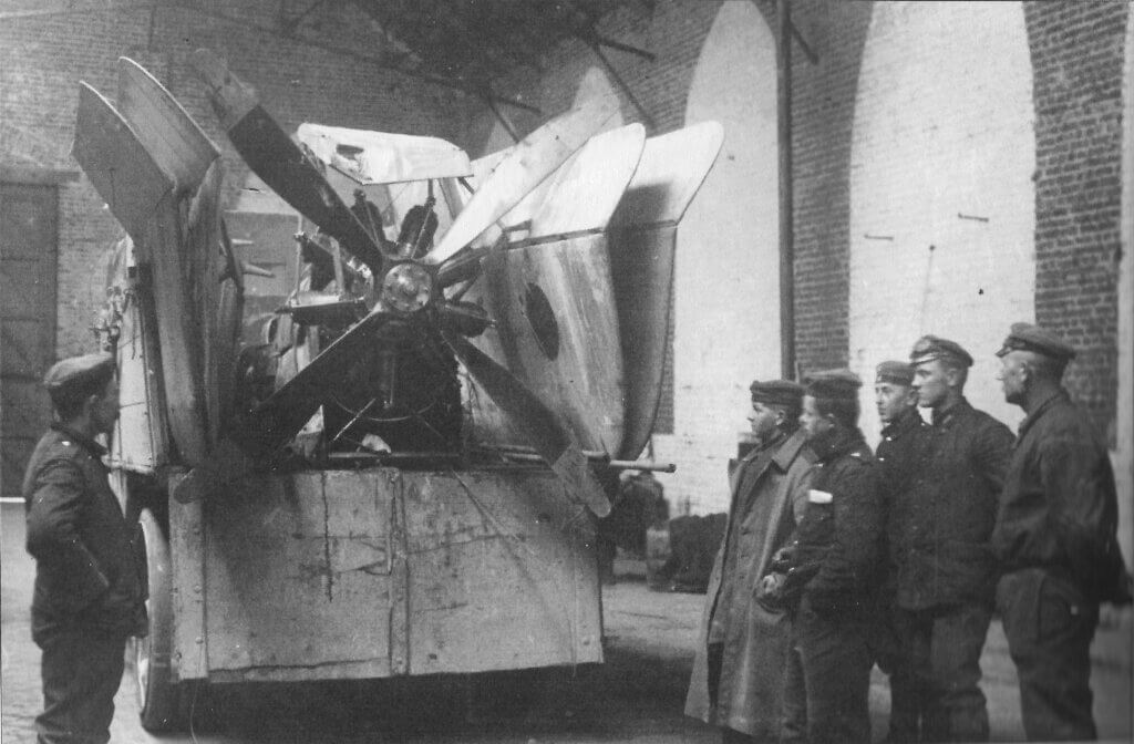 a group of men standing next to a truck